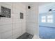Modern shower with white tiles, gray mosaic accents, and black shower fixture at 228 W Simon Nw Ter, Atlanta, GA 30318