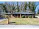 Charming brick home featuring a covered porch and a well-manicured front yard at 228 W Simon Nw Ter, Atlanta, GA 30318