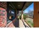 Spacious covered porch with brick siding and modern wood accents, showing outdoor living space at 228 W Simon Nw Ter, Atlanta, GA 30318