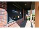 View of the front porch showcasing brick siding, modern wood columns, and natural light at 228 W Simon Nw Ter, Atlanta, GA 30318