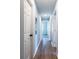 Long hallway featuring hardwood floors, white doors, and light gray walls at 228 W Simon Nw Ter, Atlanta, GA 30318
