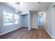 Hallway view to laundry room with modern light fixture and wood-look floors at 228 W Simon Nw Ter, Atlanta, GA 30318