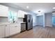 Modern kitchen with stainless steel appliances, white cabinets and wood-look floors at 228 W Simon Nw Ter, Atlanta, GA 30318