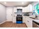 Updated kitchen with white cabinets, stainless sink and blue oven at 228 W Simon Nw Ter, Atlanta, GA 30318
