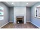 Open-concept living area with gray-painted walls, a fireplace, and elegant hardwood flooring at 228 W Simon Nw Ter, Atlanta, GA 30318