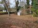 View of a large backyard with mature trees and two storage sheds at , Decatur, GA 30032