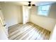 This cozy bedroom features neutral walls, plank flooring, a window, and a ceiling fan with light at , Decatur, GA 30032