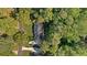 An aerial view of a property surrounded by trees, showing its generous lot size in a desirable neighborhood at 1585 Lazy River Ln, Sandy Springs, GA 30350