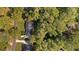 Aerial view of a home nestled among lush trees, showcasing its private and secluded location within the neighborhood at 1585 Lazy River Ln, Sandy Springs, GA 30350