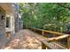 Expansive wooden deck perfect for outdoor entertaining, surrounded by lush greenery and beautiful wooded views at 1585 Lazy River Ln, Sandy Springs, GA 30350