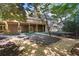 Landscaped backyard featuring a stone patio, multi-level deck, and lush greenery offering a private retreat at 1585 Lazy River Ln, Sandy Springs, GA 30350