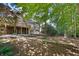 Private backyard oasis with mature trees, multi-level deck, patio, and manicured landscaping at 1585 Lazy River Ln, Sandy Springs, GA 30350