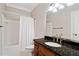 Traditional bathroom with a granite countertop vanity, tiled flooring and standard shower and tub at 1585 Lazy River Ln, Sandy Springs, GA 30350