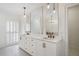 Bright bathroom featuring a double vanity with modern lighting and fixtures, and tiled flooring at 1585 Lazy River Ln, Sandy Springs, GA 30350