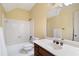 Bathroom featuring white tiled shower/tub combination, a single sink vanity, and a hexagon-tiled floor at 1585 Lazy River Ln, Sandy Springs, GA 30350