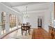 Bright dining room with coffered ceilings, terra cotta tile floors, and access to the deck at 1585 Lazy River Ln, Sandy Springs, GA 30350