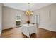 Formal dining room with hardwood floors, wainscoting, and a chandelier, perfect for elegant dinners at 1585 Lazy River Ln, Sandy Springs, GA 30350