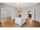 Dining room with hardwood floors, wainscoting details, and a view into the kitchen, perfect for gatherings at 1585 Lazy River Ln, Sandy Springs, GA 30350