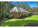 A beautiful home, mature landscaping, with an attached garage and classic architectural details, sitting on a private lot at 1585 Lazy River Ln, Sandy Springs, GA 30350