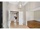 Elegant foyer with paneled walls, tile flooring, and an ornate chandelier, creating a grand entrance at 1585 Lazy River Ln, Sandy Springs, GA 30350