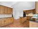 Kitchen featuring wood cabinetry, tile floors, an island and dark granite countertops at 1585 Lazy River Ln, Sandy Springs, GA 30350