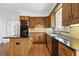 Traditional kitchen features granite counters, tile floors, and wooden cabinets at 1585 Lazy River Ln, Sandy Springs, GA 30350