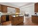 Kitchen view showing wood cabinets, an island, and breakfast area with deck view at 1585 Lazy River Ln, Sandy Springs, GA 30350