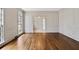 Open living room with hardwood floors, ornate molding, large windows, and recessed lighting creating a bright ambiance at 1585 Lazy River Ln, Sandy Springs, GA 30350