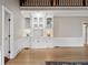 Bright living room with a built-in display cabinet, hardwood floors, and wainscoting at 1585 Lazy River Ln, Sandy Springs, GA 30350