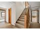 Carpeted staircase with a wooden railing, connecting multiple levels of the home at 1585 Lazy River Ln, Sandy Springs, GA 30350