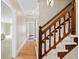 Hallway featuring hardwood floors and a wooden staircase with carpeted steps at 1585 Lazy River Ln, Sandy Springs, GA 30350