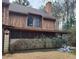 View of the home's side, showcasing the screened porch and natural wood exterior at 43 Willowick Ct, Stonecrest, GA 30038