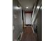 Hallway with hardwood floors, grey walls, leading to the front door and staircase at 43 Willowick Ct, Stonecrest, GA 30038