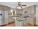 Modern kitchen featuring granite countertops, stainless steel appliances, and a center island with breakfast bar seating at 75 Price W Dr, Locust Grove, GA 30248