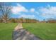 Driveway leading to pasture with trees on each side at 75 Price W Dr, Locust Grove, GA 30248