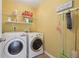 A tidy laundry room featuring white appliances and shelving at 1110 Croftmoore Lndg, Suwanee, GA 30024