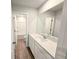 Modern bathroom featuring a large mirror, white vanity, and a full tub/shower at 2389 Brown Dove Way (5), Grayson, GA 30017