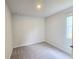 Bright, carpeted bedroom featuring a window with natural light at 2389 Brown Dove Way (5), Grayson, GA 30017