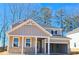 Charming new construction home with a brick-accented front porch and attached carport at 2389 Brown Dove Way (5), Grayson, GA 30017