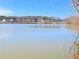 Scenic view of a serene lake, with houses visible in the distance at 2389 Brown Dove Way (5), Grayson, GA 30017