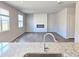 Open-concept living room featuring a modern fireplace, wood floors and lots of natural light at 2389 Brown Dove Way (5), Grayson, GA 30017