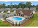 Community pool with lounge chairs, tables, landscaping, and a clubhouse at 2445 Westlington Cir, Cumming, GA 30040