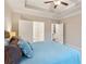 Spacious main bedroom featuring a ceiling fan and entry doors leading to other rooms at 2445 Westlington Cir, Cumming, GA 30040