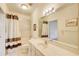 Bright bathroom featuring a shower-tub combo, vanity with sink and updated lighting at 589 Cook Dr, Ellenwood, GA 30294