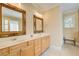 A bathroom featuring a double vanity with wooden cabinets and a large mirror at 589 Cook Dr, Ellenwood, GA 30294