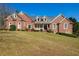 Beautiful brick home with a manicured lawn, showcasing classic architectural details at 589 Cook Dr, Ellenwood, GA 30294
