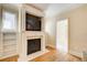 Cozy fireplace with a built-in TV and shelving at 589 Cook Dr, Ellenwood, GA 30294