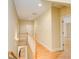 A hallway features hardwood floors and a staircase with white railings that leads to the second floor at 589 Cook Dr, Ellenwood, GA 30294