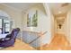 Hallway featuring hardwood floors, a leather chair, and views of the living room at 589 Cook Dr, Ellenwood, GA 30294