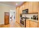 Well-lit kitchen featuring stainless steel appliances, granite countertops, and light wood cabinetry at 589 Cook Dr, Ellenwood, GA 30294